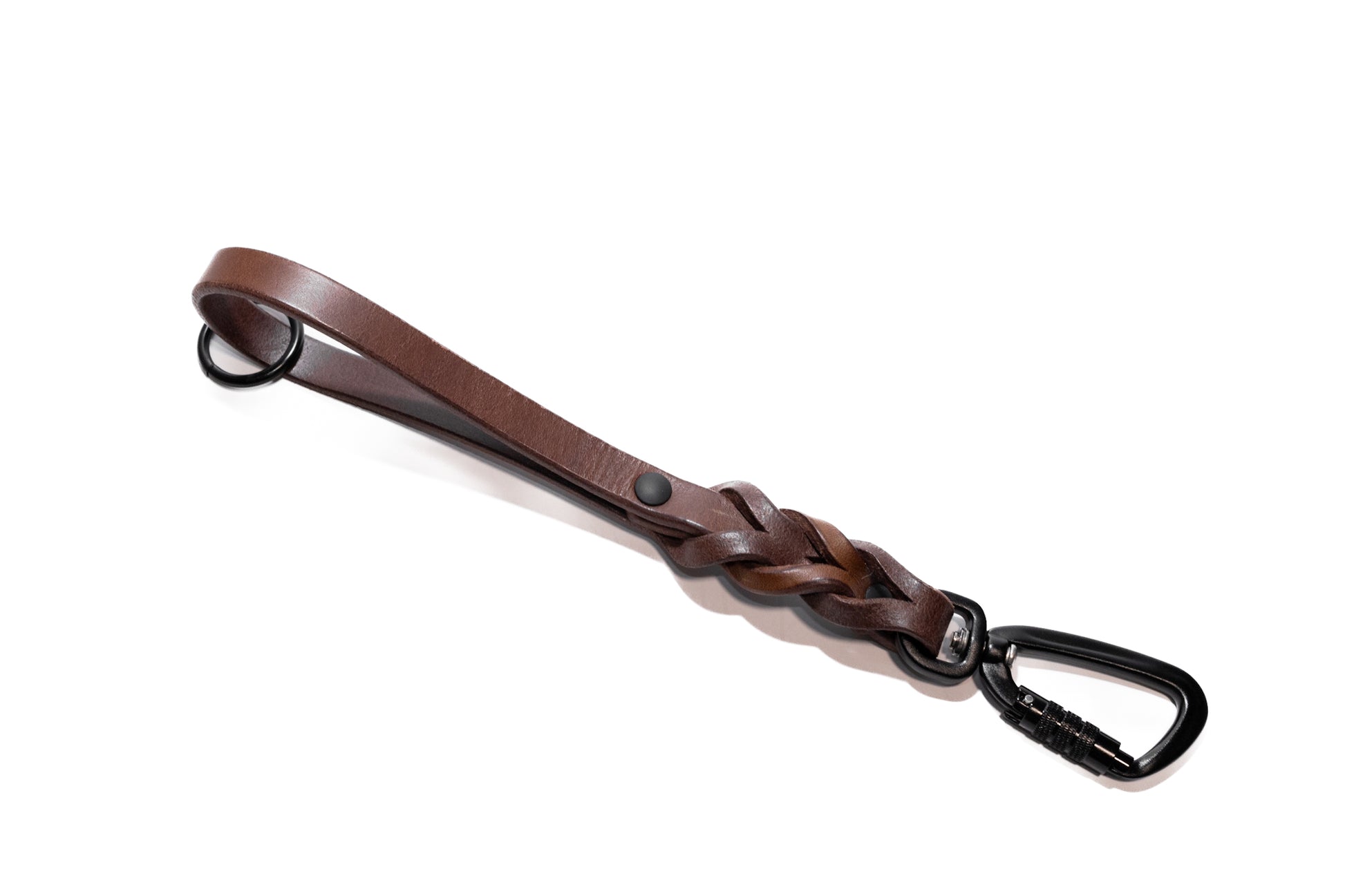 Handcrafted braided full grain leather dog training tab or handle. Featuring high quality, heavy-duty black hardware, including a swivel auto-locking carabiner. Cross Winds Leather.