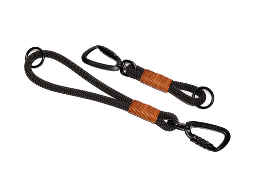 Handcrafted climbing rope and leather dog training tab or handle. Featuring high quality, heavy-duty black hardware, including a swivel auto-locking carabiner. Cross Winds Leather.