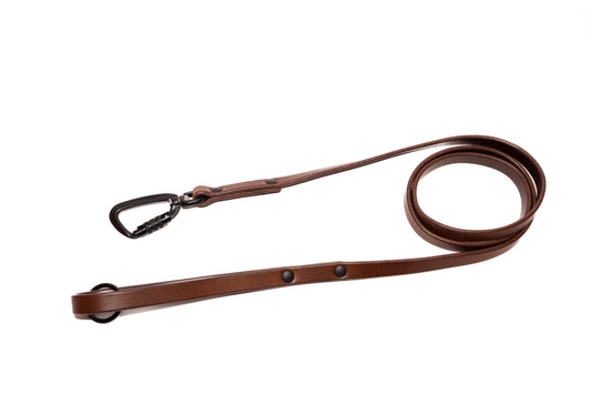 Handcrafted full grain traditional leather dog leash. Featuring high quality black hardware, including a swivel auto-locking carabiner. Multiple widths. Cross Winds Leather.