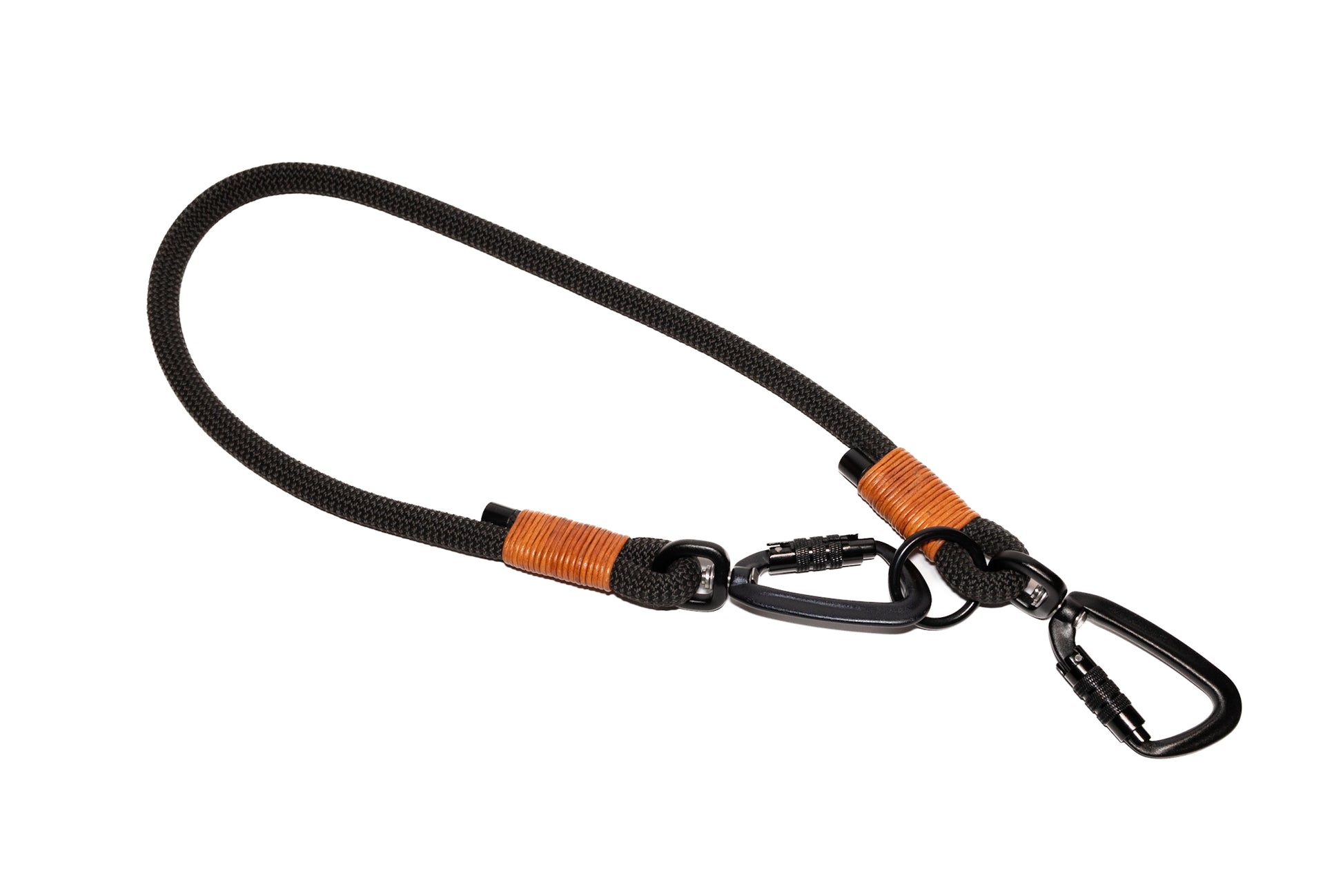 Handcrafted climbing rope and leather hand-free connector for dog walking. Featuring high quality black hardware, including swivel auto-locking carabiners. Cross Winds Leather.
